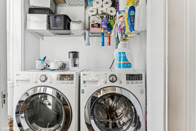 clothes washing area featuring laundry area and washing machine and clothes dryer