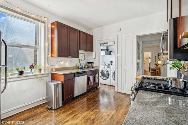 kitchen featuring plenty of natural light, washer and dryer, appliances with stainless steel finishes, and a sink