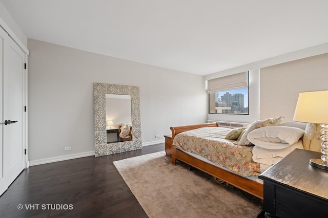 bedroom featuring dark wood finished floors and baseboards