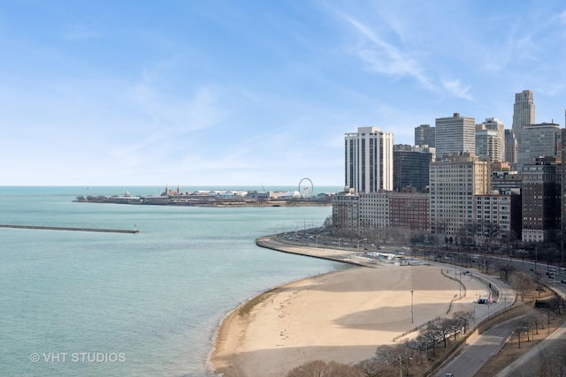 water view featuring a city view and a beach view