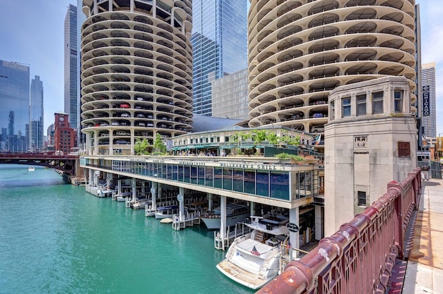 view of dock with a water view and a city view