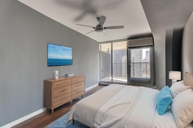 bedroom featuring baseboards, ceiling fan, dark wood-style flooring, and access to exterior