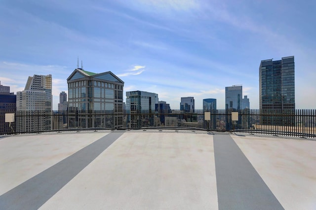 view of patio / terrace featuring a city view and fence