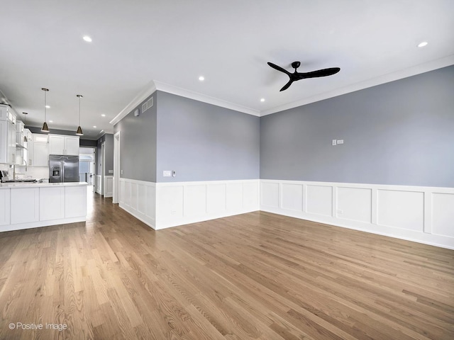 unfurnished living room featuring recessed lighting, visible vents, ornamental molding, ceiling fan, and light wood-type flooring