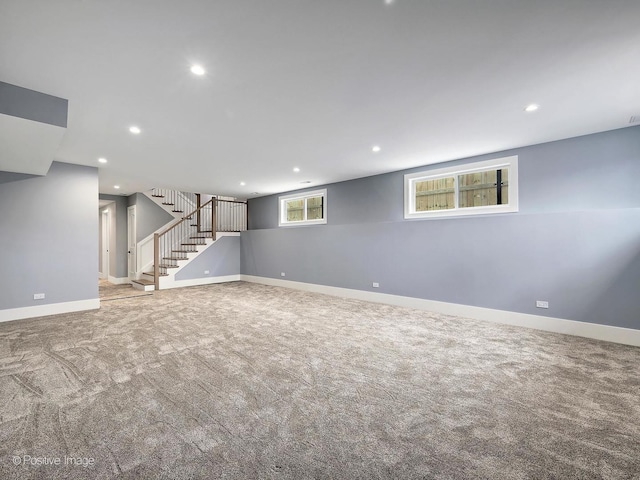 basement with stairway, recessed lighting, carpet flooring, and baseboards