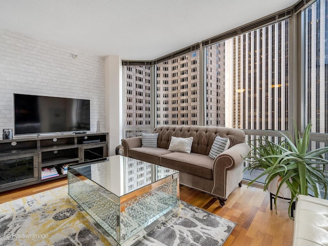 living area with a textured ceiling and wood finished floors