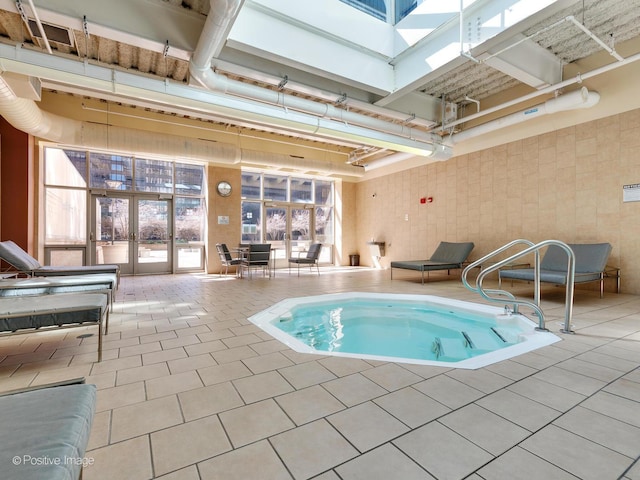 view of swimming pool featuring french doors and an indoor in ground hot tub