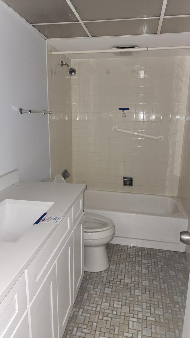 full bath with vanity, toilet, and bathing tub / shower combination