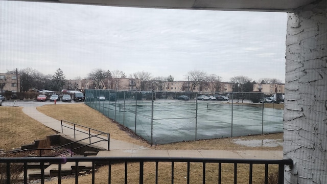 view of pool with a tennis court and fence