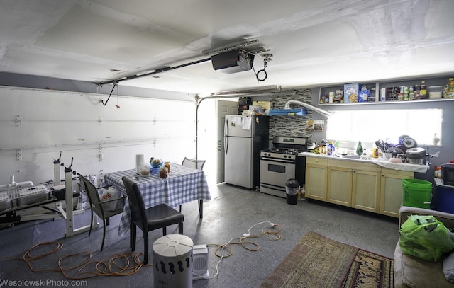 garage featuring freestanding refrigerator and a garage door opener