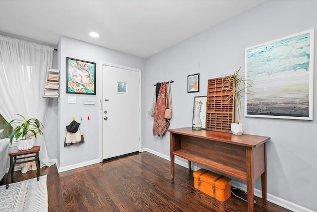 foyer with dark wood-type flooring, recessed lighting, and baseboards