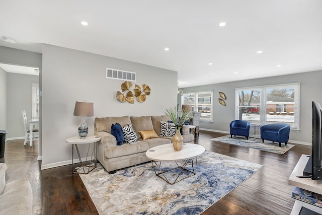 living area with dark wood-style flooring, recessed lighting, visible vents, and baseboards