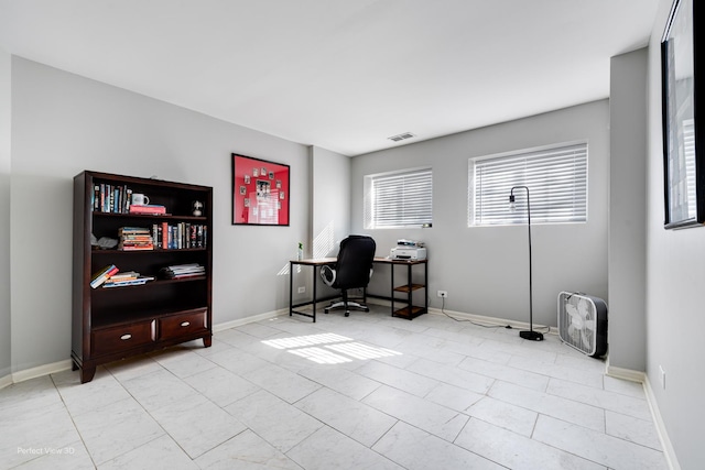 office space with visible vents and baseboards