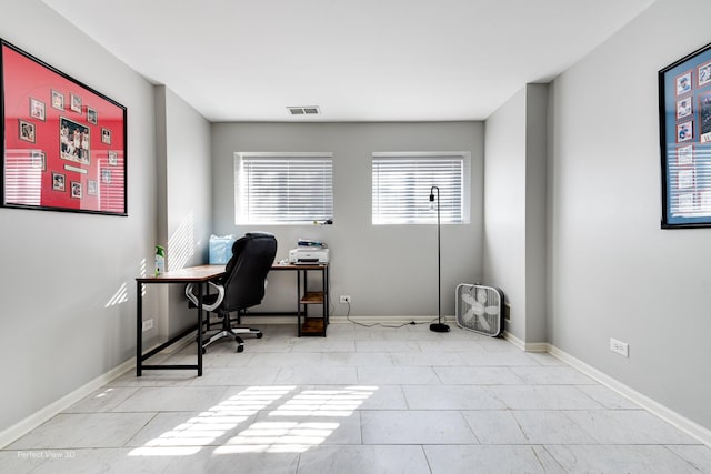 office with light tile patterned floors, baseboards, and visible vents