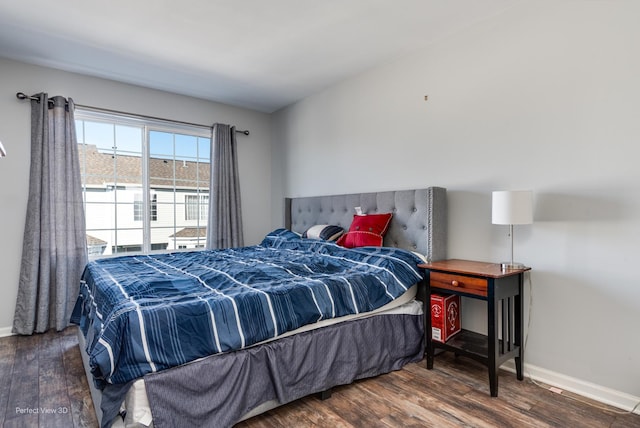 bedroom featuring dark wood-style floors and baseboards