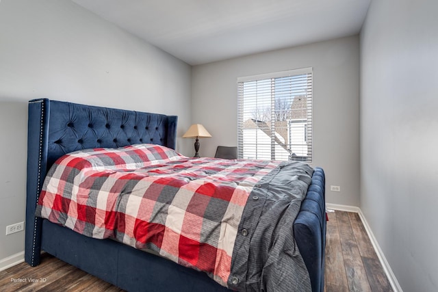 bedroom featuring dark wood finished floors and baseboards