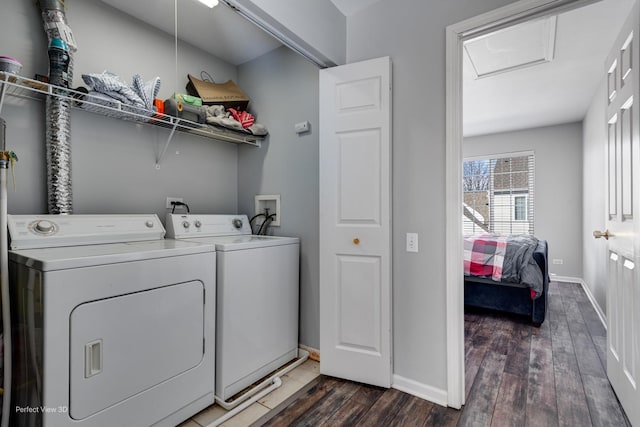 laundry area with laundry area, baseboards, dark wood-style flooring, and washer and dryer