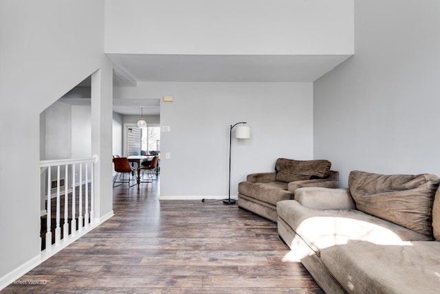 living area with baseboards and wood finished floors