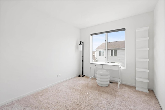 unfurnished bedroom featuring light carpet and baseboards