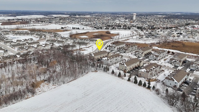 snowy aerial view with a residential view