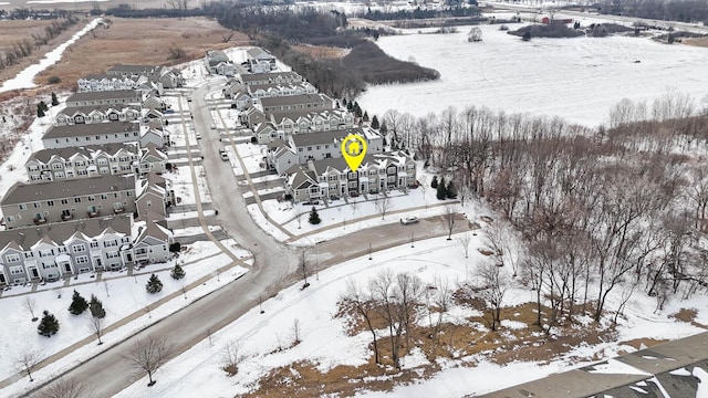 snowy aerial view with a residential view