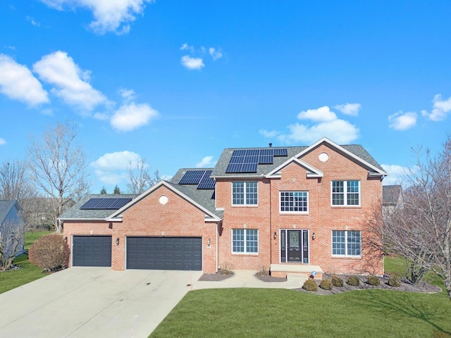 view of front of home featuring a garage, driveway, a front lawn, and brick siding