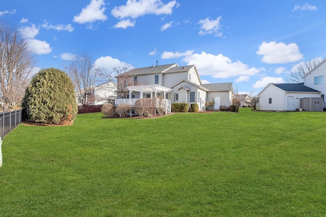 back of property with a yard, a fenced backyard, and a pergola