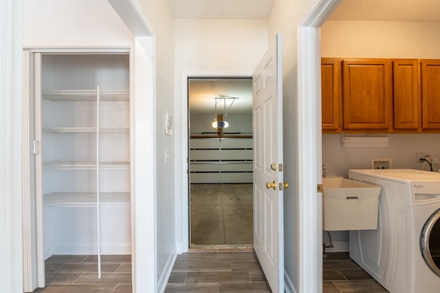 laundry room with wood finish floors, washer / dryer, and cabinet space