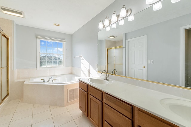 full bath featuring visible vents, a sink, a shower stall, tile patterned flooring, and a bath