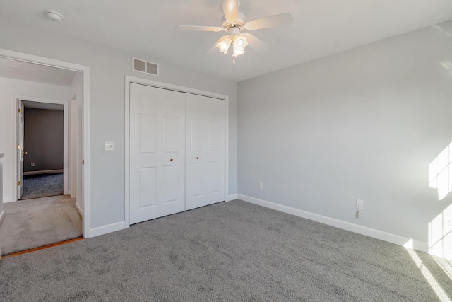 unfurnished bedroom with baseboards, a closet, visible vents, and carpet flooring