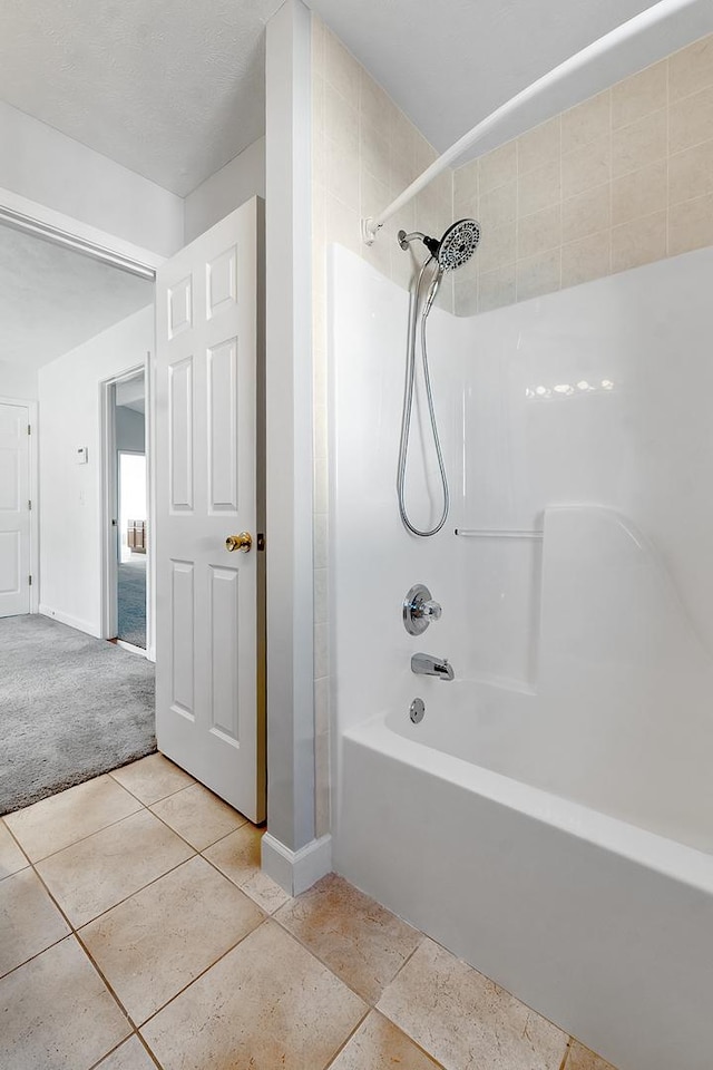 full bathroom featuring shower / bath combination, baseboards, and tile patterned floors