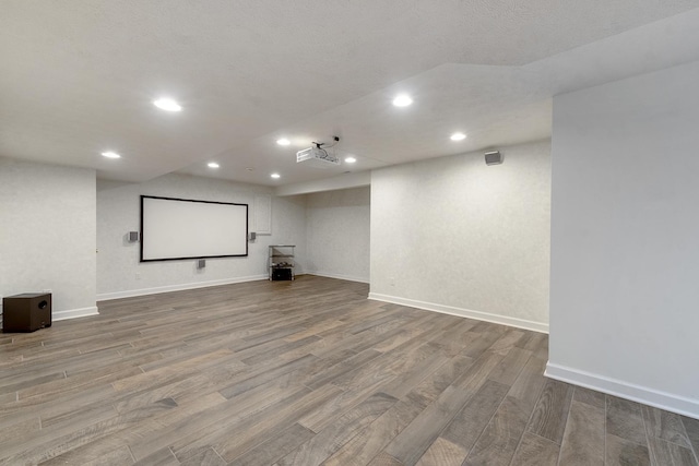 home theater with recessed lighting, baseboards, and wood finished floors