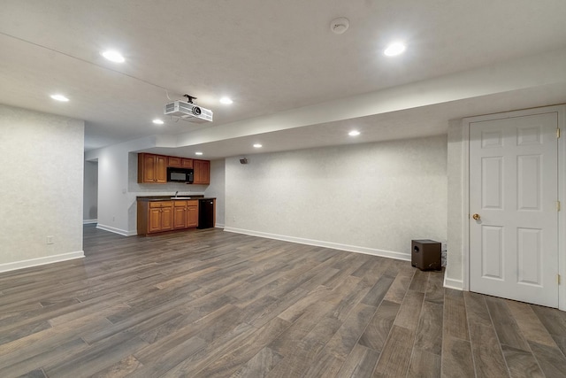 interior space featuring dark wood-type flooring, recessed lighting, and baseboards