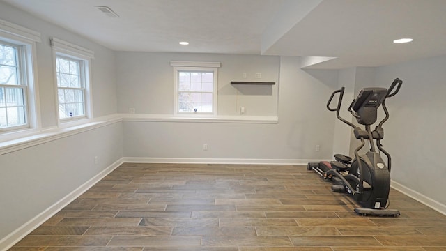 workout room featuring wood finish floors, recessed lighting, visible vents, and baseboards