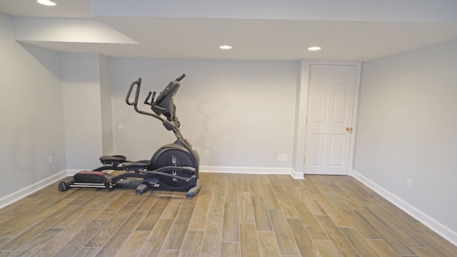 exercise area featuring recessed lighting, baseboards, and wood finished floors