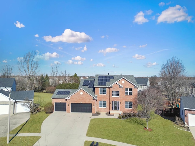 view of front of property with a garage, a front lawn, solar panels, and concrete driveway