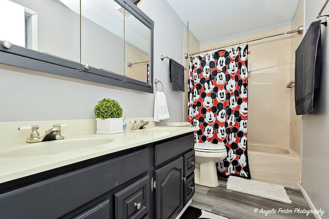 bathroom with shower / bath combo, a sink, toilet, and double vanity