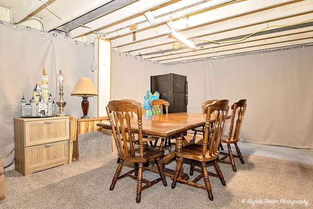 dining area featuring light carpet