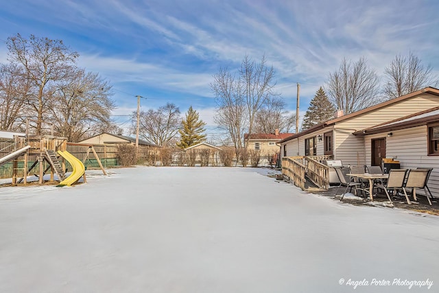 view of yard with a playground and fence