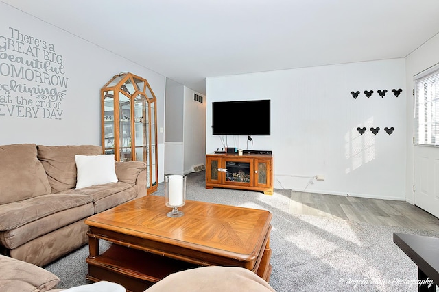 living room with wood finished floors and visible vents