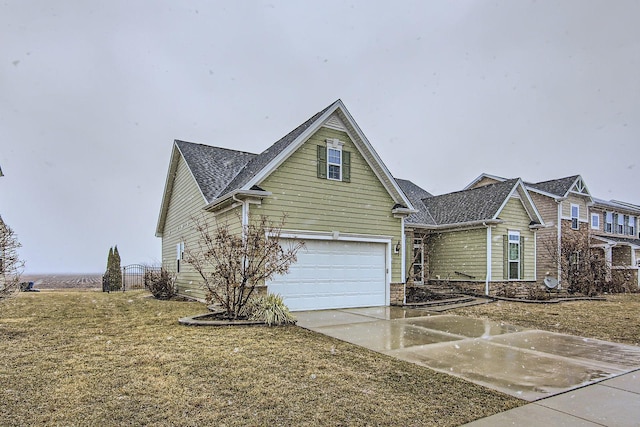 view of front facade featuring concrete driveway, a garage, and a front yard