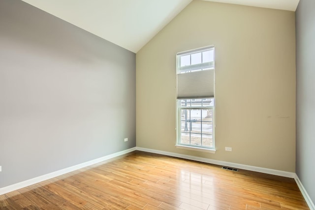 empty room with visible vents, light wood-style flooring, and baseboards