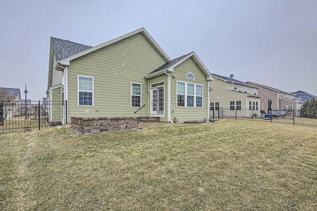 rear view of property with a yard and a fenced backyard