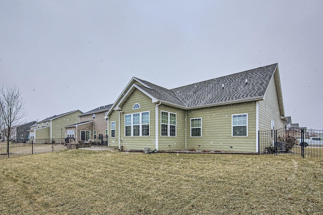 back of property featuring a lawn and a fenced backyard