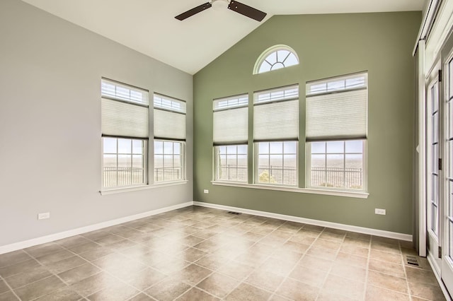 empty room with tile patterned floors, visible vents, high vaulted ceiling, baseboards, and ceiling fan