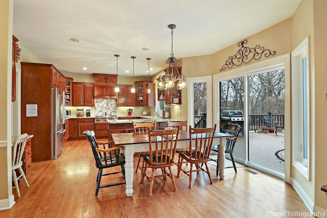 dining room with a notable chandelier, recessed lighting, visible vents, baseboards, and light wood-type flooring