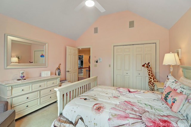 bedroom with ceiling fan, light carpet, visible vents, vaulted ceiling, and a closet