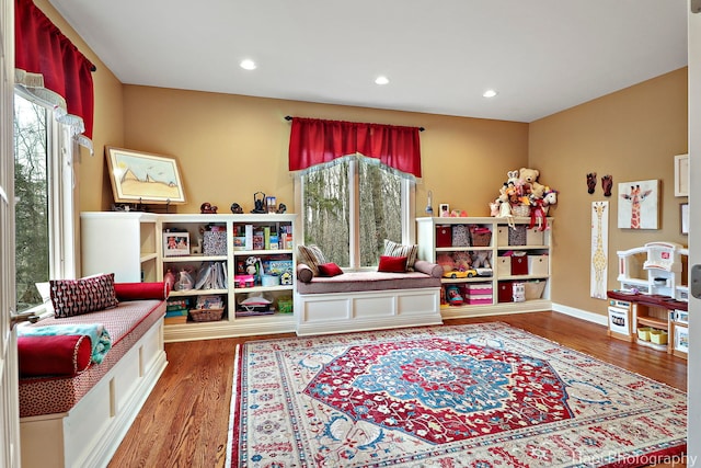 game room with baseboards, wood finished floors, and recessed lighting