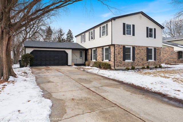 view of front of property featuring concrete driveway, brick siding, and an attached garage