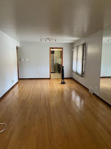 unfurnished room with visible vents and light wood-style floors